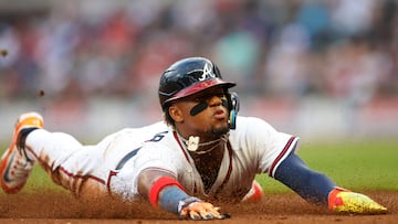 Apr 25, 2023; Atlanta, Georgia, USA; Atlanta Braves right fielder Ronald Acuna Jr. (13) slides into third with a stolen base against the Miami Marlins in first inning at Truist Park. Mandatory Credit: Brett Davis-USA TODAY Sports