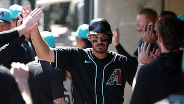 SCOTTSDALE, ARIZONA - FEBRUARY 25: Nolan Arenado #28 of the Arizona Diamondbacks high fives teammates in the dugout after scoring a run against the Los Angeles Dodgers in the first inning of a spring training game at Salt River Fields at Talking Stick on February 25, 2026 in Scottsdale, Arizona. Chris Coduto/Getty Images/AFP (Photo by Chris Coduto / GETTY IMAGES NORTH AMERICA / Getty Images via AFP)