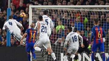 Real Madrid's defender Sergio Ramos (L) heads the ball to score a goal during the Spanish league football match FC Barcelona vs Real Madrid CF at the Camp Nou stadium in Barcelona on December 3, 2016. / AFP PHOTO / LLUIS GENE