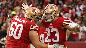 SANTA CLARA, CALIFORNIA - DECEMBER 11: Christian McCaffrey #23 of the San Francisco 49ers celebrates with Daniel Brunskill #60 after running for a touchdown during the third quarter against the Tampa Bay Buccaneers at Levi's Stadium on December 11, 2022 in Santa Clara, California.   Lachlan Cunningham/Getty Images/AFP (Photo by Lachlan Cunningham / GETTY IMAGES NORTH AMERICA / Getty Images via AFP)