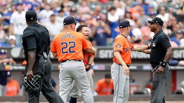 NEW YORK, NEW YORK - JUNE 30: Bench coach Omar Lopez #22 and manager Joe Espada #19 of the Houston Astros get between Jose Altuve #27 and umpires James Jean (L) and Alan Porter after Altuve was ejected from a game against the New York Mets during the seventh inning at Citi Field on June 30, 2024 in New York City.   Jim McIsaac/Getty Images/AFP (Photo by Jim McIsaac / GETTY IMAGES NORTH AMERICA / Getty Images via AFP)