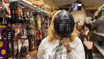 MADRID, SPAIN - OCTOBER 28:  A woman poses with a mask from the Netflix TV series &#039;The Squid Game&#039; on October 28, 2021 in Madrid, Spain.  Many Halloween events and large-scale decorations are back this year after many events were cancelled in 20