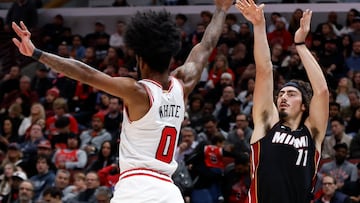 Nov 20, 2023; Chicago, Illinois, USA; Miami Heat guard Jaime Jaquez Jr. (11) shoots against Chicago Bulls guard Coby White (0) during the second half at United Center. Mandatory Credit: Kamil Krzaczynski-USA TODAY Sports