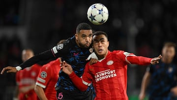 PSV Eindhoven's American defender #08 Sergino Dest (L) fights for the ball with Sevilla's Moroccan forward #15 Youssef En-Nesyri during the UEFA Champions League 1st round Group B football match between PSV Eindhoven and Sevilla FC at the Phillips Stadium in Eindhoven, on October 3, 2023. (Photo by JOHN THYS / AFP)