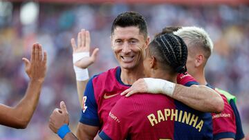 Barcelona's Raphinha, front, is congratulated after scoring his side's 4th goal during the Spanish La Liga soccer match between FC Barcelona and Valladolid at the Olympic stadium in Barcelona, Spain, Saturday, Aug. 31, 2024. (AP Photo/Joan Monfort)