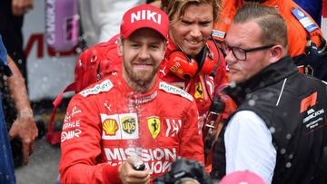 Second placed Ferrari&#039;s German driver Sebastian Vettel (L) spills champagne after the Monaco Formula 1 Grand Prix at the Monaco street circuit on May 26, 2019 in Monaco. (Photo by YANN COATSALIOU / AFP)