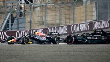 Red Bull Racing's Dutch driver Max Verstappen (L) drives as Mercedes' British driver Lewis Hamilton (R) slides off the track during the Qatari Formula One Grand Prix at Lusail International Circuit on October 8, 2023. (Photo by Giuseppe CACACE / AFP)