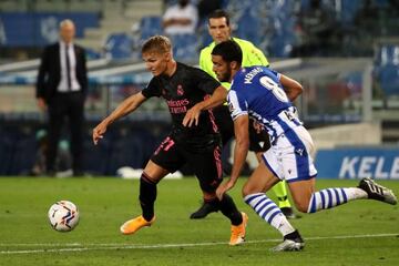 Martin Odegaard in action against Real Sociedad's Mikel Merino.