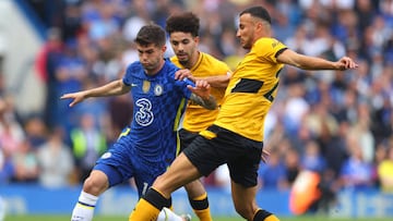 LONDON, ENGLAND - MAY 07: Christian Pulisic of Chelsea is challenged by Rayan Ait-Nouri and Romain Saiss of Wolverhampton Wanderers  during the Premier League match between Chelsea and Wolverhampton Wanderers at Stamford Bridge on May 07, 2022 in London, England. (Photo by Catherine Ivill/Getty Images)