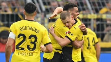 Dortmund's Norwegian defender #26 Julian Ryerson (R) celebrates scoring the 4-2 goal with his team-mate Dortmund's German midfielder #08 Felix Nmecha during the German first division Bundesliga football match between Borussia Dortmund and 1 FC Union Berlin in Dortmund, western Germany on October 7, 2023. (Photo by INA FASSBENDER / AFP) / DFL REGULATIONS PROHIBIT ANY USE OF PHOTOGRAPHS AS IMAGE SEQUENCES AND/OR QUASI-VIDEO