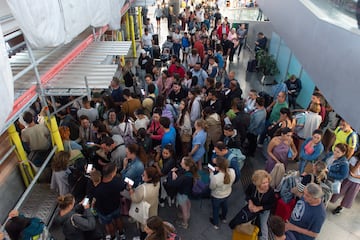 Cientos de viajeros con sus viajes cancelados esperan en la Estación de Atocha-Almudena Grandes. La empresa de transporte ferroviario permite anular o cambiar sin gastos los viajes de este domingo afectados por el temporal.