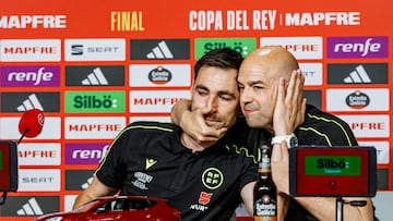 This handout picture taken and released by the Spanish Royal Football Federation (RFEF) on April 25, 2025 shows Spanish referee Pablo Gonzalez Fuertes (R) comforting Spanish referee Ricardo De Burgos Bengoechea during a press conference ahead of the King's Cup final, at La Cartuja stadium in Seville on April 25, 2025. Referee of the final of the King�s Cup between FC Barcelona and Real Madrid on April 26, 2025 Ricardo de Burgos Bengoechea denounced, in tears, the constant pressure from Real Madrid TV and its consequences at the family level. (Photo by Pablo GARCIA / RFEF / AFP) / RESTRICTED TO EDITORIAL USE - MANDATORY CREDIT "AFP PHOTO / Pablo Garcia/ Spanish Royal Football Federation (RFEF) " - NO MARKETING NO ADVERTISING CAMPAIGNS - DISTRIBUTED AS A SERVICE TO CLIENTS