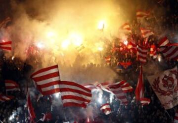 Red Star fans light flares and wave flags as they cheer for their team during their Serbian Superleague soccer match against Partizan Belgrade in Belgrade,