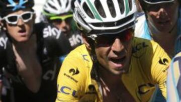 The pack of riders including Leader's yellow jersey, Astana team rider Vincenzo Nibali, of Italy cycles on its way during the 187.5-km 11th stage of the Tour de France cycling race between Besancon and Oyonnax, July 16, 2014. REUTERS/Christian Hartmann (FRANCE - Tags: SPORT CYCLING)
