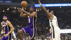 Mar 19, 2019; Milwaukee, WI, USA; Los Angeles Lakers guard Rajon Rondo (9) shoots beyond the reach of Milwaukee Bucks guard Eric Bledsoe (6) during the first quarter at Fiserv Forum. Mandatory Credit: Jeff Hanisch-USA TODAY Sports