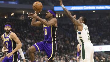 Mar 19, 2019; Milwaukee, WI, USA; Los Angeles Lakers guard Rajon Rondo (9) shoots beyond the reach of Milwaukee Bucks guard Eric Bledsoe (6) during the first quarter at Fiserv Forum. Mandatory Credit: Jeff Hanisch-USA TODAY Sports