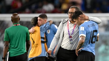 AL WAKRAH, QATAR - DECEMBER 02: Mathias Olivera of Uruguay is consoled after the team fails to qualify for the knockout stage despite their 2-0 victory in the FIFA World Cup Qatar 2022 Group H match between Ghana and Uruguay at Al Janoub Stadium on December 02, 2022 in Al Wakrah, Qatar. (Photo by Clive Mason/Getty Images)