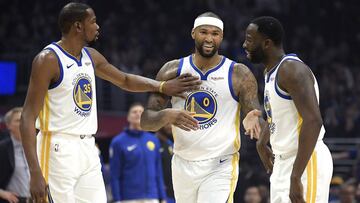 Golden State Warriors forward Kevin Durant, left, pats center DeMarcus Cousins, center, on the chest as forward Draymond Green smiles during the first half of the team's NBA basketball game against the Los Angeles Clippers on Friday, Jan. 18, 2019, in Los Angeles. (AP Photo/Mark J. Terrill)