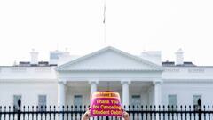 An activist holds a sign thanking US President Joe Biden for cancelling student debt, during a rally in front of the White House in Washington, DC, on August 25, 2022. - Biden announced on August 24, 2022, that most US university graduates still trying to pay off student loans will get $10,000 of relief to address a decades-old headache of massive educational debt across the country. (Photo by Stefani Reynolds / AFP) (Photo by STEFANI REYNOLDS/AFP via Getty Images)