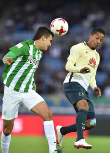 Club America defender Gil Buron (L) headers the ball as Club America's Michael Arroyo (R) reacts during the Club World Cup third-place playoff football match between Atletico Nacional of Colombia and Club America of Mexico at Yokohama International stadium in Yokohama on December 18, 2016. / AFP PHOTO / Kazuhiro NOGI