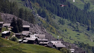A helicopter drops equipment in Ried, next to debris and dust from a crumbling glacier that partially collapsed and tumbled onto the village of Blatten, Switzerland is seen on May 29, 2025. REUTERS/Stefan Wermuth