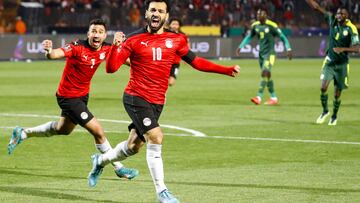 Egypt's forward Mohamed Salah (R) and Egypt's midfielder Mahmoud 'Trezeguet' Hassan (L) celebrate after a goal during the 2022 Qatar World Cup African Qualifiers football match between Egypt and Senegal at Cairo International Stadium in the Egyptian capital on March 25, 2022. (Photo by Khaled DESOUKI / AFP)