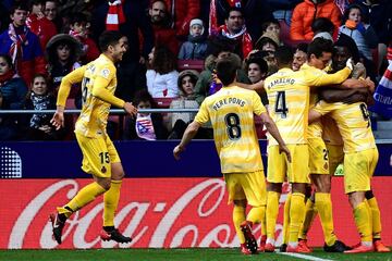 Cristian 'Portu' Portugués celebrates with teammates after scoring a goal.