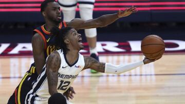 Memphis Grizzlies' Ja Morant (12) shoots against Golden State Warriors' Andrew Wiggins during the second half of an NBA basketball Western Conference play-in game in San Francisco, Friday, May 21, 2021. (AP Photo/Jed Jacobsohn)