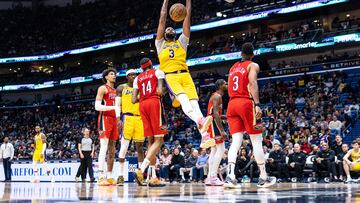 Mar 14, 2023; New Orleans, Louisiana, USA; Los Angeles Lakers forward Anthony Davis (3) dunks the ball against New Orleans Pelicans forward Brandon Ingram (14) during the second half at Smoothie King Center. Mandatory Credit: Stephen Lew-USA TODAY Sports