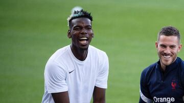 (FILES) In this file photo taken on September 2, 2021 Francex92s midfielder Paul Pogba plays with Francex92s midfielder Jordan Veretout (R) as they take part in a training session at the Meineau Stadium in Strasbourg ahead of their FIFA World Cup Qatar 20