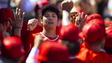 Mar 21, 2022; Tempe, Arizona, USA; Los Angeles Angels pitcher Shohei Ohtani celebrates with teammates in the dugout against the Kansas City Royals during spring training at Tempe Diablo Stadium. Mandatory Credit: Mark J. Rebilas-USA TODAY Sports