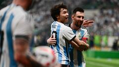 A fan (C) embraces Argentina's Lionel Messi (R) during a friendly football match between Australia and Argentina at the Workers' Stadium in Beijing on June 15, 2023. (Photo by Pedro PARDO / AFP)