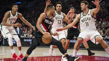 Nov 6, 2018; Portland, OR, USA; Portland Trail Blazers guard CJ McCollum (3) looks for an opening as he is guarded by Milwaukee Bucks forward Giannis Antetokounmpo (34), guard Malcolm Brogdon (13) and center Brook Lopez (11) at Moda Center. Mandatory Credit: Troy Wayrynen-USA TODAY Sports