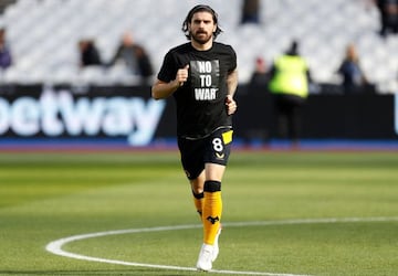 Wolverhampton Wanderers' Portuguese midfielder Ruben Neves, wearing a t-shirt with the slogan "No to War" referring to Russia's invasion of Ukraine