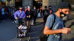 People wearing faces masks as a protection against the coronavirus disease (COVID-19) walk outside the Retiro train station, in Buenos Aires, Argentina March 31, 2021. REUTERS/Agustin Marcarian