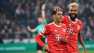 Bayern Munich's Cameroonian forward Eric Maxim Choupo-Moting (R) reacts with Bayern Munich's German midfielder Jamal Musiala during the German first division Bundesliga football match between Schalke 04 v Bayern Munich in Gelsenkirchen, western Germany, on November 12, 2022. (Photo by UWE KRAFT / AFP) / DFL REGULATIONS PROHIBIT ANY USE OF PHOTOGRAPHS AS IMAGE SEQUENCES AND/OR QUASI-VIDEO