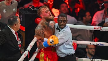El árbitro Christopher Young mantiene al boxeador e influencer estadounidense Jake Paul contra las cuerdas durante su pelea contra el boxeador británico Anthony Joshua.