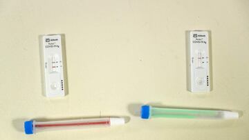A picture taken on December 15, 2020 shows two samples of Covid-19 coronavirus' test, one of them is negative (R) and the other one is positive (L) during a Covid-19 mass testing campaign in Montivillliers, northern France. - In order to deploy the n