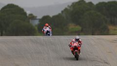 Ducati Spanish rider Marc Marquez (L) and Ducati Italian rider Enea Bastianini take part in the MotoGP first free practice session of the Portuguese Grand Prix at the Algarve International Circuit in Portimao on March 22, 2024. (Photo by PATRICIA DE MELO MOREIRA / AFP)