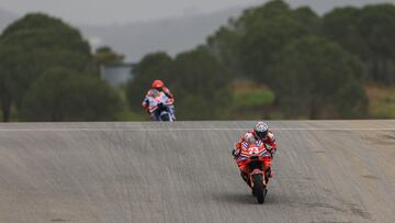 Ducati Spanish rider Marc Marquez (L) and Ducati Italian rider Enea Bastianini take part in the MotoGP first free practice session of the Portuguese Grand Prix at the Algarve International Circuit in Portimao on March 22, 2024. (Photo by PATRICIA DE MELO MOREIRA / AFP)