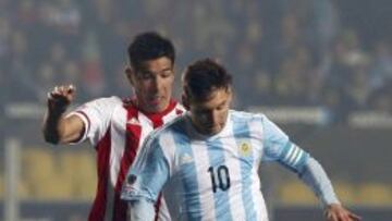 Paraguay's Victor Caceres (rear) challenges Argentina's Lionel Messi during their Copa America 2015 semi-final soccer match at Estadio Municipal Alcaldesa Ester Roa Rebolledo in Concepcion, Chile, June 30, 2015. REUTERS/Andres Stapff