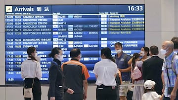 People wearing face masks are seen at an arrival lobby of Haneda airport in Tokyo on Aug. 23, 2022, amid the coronavirus pandemic. (Photo by Kyodo News via Getty Images)