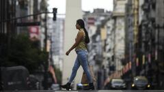 BUENOS AIRES, ARGENTINA - MARCH 31:  A woman crosses the Corrientes avenue on March 31, 2020 in Buenos Aires, Argentina. Last Sunday President Fernandez announced an extension of the total lock down to stop spread of COVID-19 until April 13. The Coronavirus (COVID-19) pandemic has spread to many countries across the world, claiming over 38,000 lives and infecting hundreds of thousands more. Argentina has informed 25 deaths so far. (Photo by Marcelo Endelli/Getty Images)