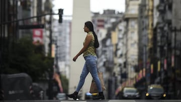 BUENOS AIRES, ARGENTINA - MARCH 31:  A woman crosses the Corrientes avenue on March 31, 2020 in Buenos Aires, Argentina. Last Sunday President Fernandez announced an extension of the total lock down to stop spread of COVID-19 until April 13. The Coronavirus (COVID-19) pandemic has spread to many countries across the world, claiming over 38,000 lives and infecting hundreds of thousands more. Argentina has informed 25 deaths so far. (Photo by Marcelo Endelli/Getty Images)