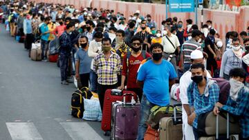 Migrant workers and their families wait in lines outside a railway station to board a train to their home state of eastern West Bengal, after authorities eased lockdown restrictions that were imposed to slow the spread of the coronavirus disease (COVID-19