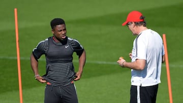 Laurent Blanc (R) chatting to Serge Aurier in training.