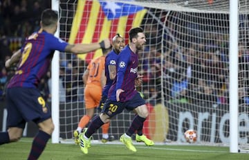 Lionel Messi of Barcelona celebrates his second goal with Arturo Vidal during the UEFA Champions League Round of 16 Second Leg match between FC Barcelona and Olympique Lyonnais