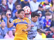 Jonathan Herrera (L) of Tigres fights fo rthe ball with Kevin Alvarez (R) of America during the friendly match between America and Tigres UANL as part the Golden Clash Mens at Donald W. Reynolds Razorback Stadium, on March 28, 2026 in Fayetteville, Arkansas, United States.