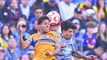 Jonathan Herrera (L) of Tigres fights fo rthe ball with Kevin Alvarez (R) of America during the friendly match between America and Tigres UANL as part the Golden Clash Mens at Donald W. Reynolds Razorback Stadium, on March 28, 2026 in Fayetteville, Arkansas, United States.