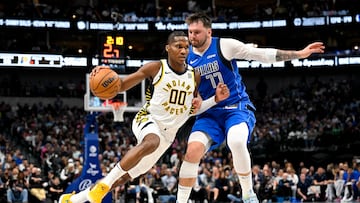 Mar 5, 2024; Dallas, Texas, USA; Indiana Pacers guard Bennedict Mathurin (00) brings the ball up court past Dallas Mavericks guard Luka Doncic (77) during the second half at the American Airlines Center. Mandatory Credit: Jerome Miron-USA TODAY Sports